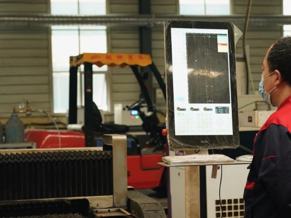 The worker is monitoring the column internal production & processing equipment